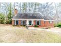 Lovely single-story red brick home featuring a well-maintained lawn and classic architectural details at 612 W Chisholm St, Sanford, NC 27330