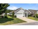 Inviting one-story home boasts a two-car garage, a well-kept lawn, and charming curb appeal at 65 Balsam Ln, Clayton, NC 27527