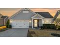 Charming home with a two-car garage, well-kept lawn and front shrubs at 65 Balsam Ln, Clayton, NC 27527