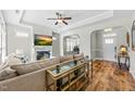Inviting living room with hardwood floors, fireplace, and open layout to front entry at 65 Balsam Ln, Clayton, NC 27527
