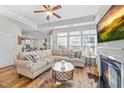 Spacious living room with open layout and fireplace, connected to eat-in kitchen at 65 Balsam Ln, Clayton, NC 27527