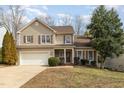 Charming two-story home with a well-manicured front yard and attached two-car garage at 708 Midsummer Ln, Apex, NC 27502