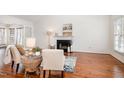 Inviting living room with hardwood floors, fireplace, and large windows at 708 Midsummer Ln, Apex, NC 27502