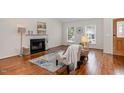 Cozy living room features a fireplace, hardwood floors, and ample natural light at 708 Midsummer Ln, Apex, NC 27502