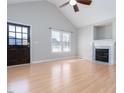 Bright living room with hardwood floors, fireplace, and vaulted ceiling at 85 Jarrett Bay Ln, Fuquay Varina, NC 27526