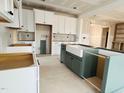 Spacious new kitchen featuring two-tone cabinets, a large farmhouse sink, and an open design to the living area at 83 Nottoway Lane, Wendell, NC 27591