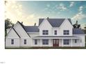 Charming two-story home with a covered front porch and a classic modern farmhouse design at 975 Wilbon Rd, Holly Springs, NC 27540