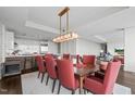 Elegant dining room featuring a large table, modern lighting, and a view to the kitchen and living spaces at 110 N Corcoran St # 2304, Durham, NC 27701