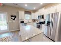 Bright kitchen featuring stainless steel appliances, granite countertops, and ample storage at 1105 Freestone Rd, Durham, NC 27703