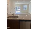 Open kitchen with stainless steel dishwasher and an island with a sink at 1117 Mountain Crown St, Durham, NC 27704