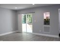 Bright living room featuring hardwood floors, recessed lighting, and sliding glass doors to deck at 1210 Shaw St, Burlington, NC 27217