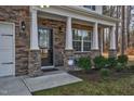 Inviting front porch with stone pillars, security system, and well-manicured shrubs at 172 Great Gln, Rocky Mount, NC 27804