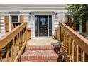 Inviting front door with decorative glass and brick steps leading to a porch at 207 Wyatts Pond Ln, Cary, NC 27513