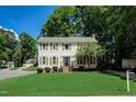 Traditional home with a well-manicured lawn and mature trees provides curb appeal at 207 Wyatts Pond Ln, Cary, NC 27513