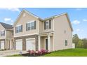 Attractive townhome with stone accents, a welcoming entryway, and a well-maintained green space at 268 Moyer Dr, Graham, NC 27253