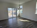 Dining room featuring luxury vinyl plank flooring, modern lighting, and sliding glass doors for easy access to outdoors at 2701 Princess Tree Dr, Raleigh, NC 27616