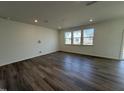 Bright living room with hardwood floors and multiple windows, perfect for entertaining and relaxation at 2701 Princess Tree Dr, Raleigh, NC 27616