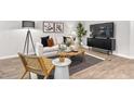 Inviting living area featuring a comfortable sofa, modern furnishings, and a large television at 280 Moyer Dr, Graham, NC 27253