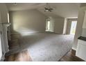 Spacious living room with vaulted ceilings, neutral walls, carpeted floors, and a fireplace at 313 Lotus Ave, Smithfield, NC 27577