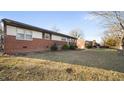 Traditional brick home featuring a well-maintained lawn and inviting curb appeal in a quiet neighborhood at 316 Watson Dr, Burlington, NC 27217