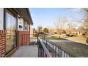 Charming front porch features classic railing and a view of the tree-lined street in a quiet neighborhood at 316 Watson Dr, Burlington, NC 27217
