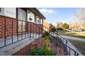 Inviting front porch with brick steps and wrought iron railing, creating a warm welcome at 316 Watson Dr, Burlington, NC 27217