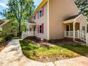 Home exterior with a tidy lawn, sidewalk, and manicured landscaping at 3553 E Jameson Rd, Raleigh, NC 27604