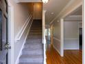 Bright foyer featuring staircase with natural light and hardwood floors at 3553 E Jameson Rd, Raleigh, NC 27604