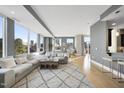 Inviting living room with natural light, comfortable seating, stylish decor, and access to a balcony at 400 W North St # 730, Raleigh, NC 27603