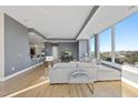 Bright living room boasts floor-to-ceiling windows offering stunning city views and hardwood flooring at 400 W North St # 730, Raleigh, NC 27603