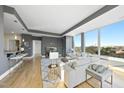 Bright, open living room with large windows offering city views, comfortable seating, and stylish decor at 400 W North St # 730, Raleigh, NC 27603