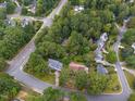 Expansive aerial view showcases a neighborhood with mature trees and well-spaced houses at 415 Englewood Dr, Chapel Hill, NC 27514