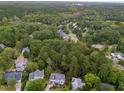 Lush aerial view displaying a neighborhood surrounded by verdant forests and winding roads at 415 Englewood Dr, Chapel Hill, NC 27514