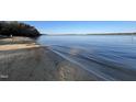 Scenic view of a serene beach with gentle waves and clear blue water at 43 New Rhododendron, Chapel Hill, NC 27517