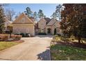 Elegant home boasting stone and siding exterior, complemented by lush landscaping at 43 New Rhododendron, Chapel Hill, NC 27517