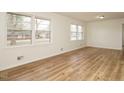 Bright living room with light-colored walls, light-colored floors, and multiple windows at 431 Mattox St, Wendell, NC 27591