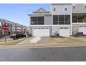 Townhome garages with screened-in porch above offering privacy at 547 Gateway Townes Blvd, Wake Forest, NC 27587
