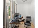 Bright home office with large windows, offering a comfortable and productive workspace at 5750 Nc Highway 49, Burlington, NC 27215
