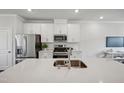 Close up of modern kitchen with stainless steel appliances and a bright white color palette at 681 Mirkwood, Apex, NC 27523