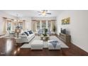 Bright living room features hardwood floors, lots of windows, and neutral tones, creating a serene and inviting atmosphere at 724 Ancient Oaks Dr, Holly Springs, NC 27540