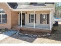 Charming front porch with brick accents, stone walkway, and inviting entrance to a cozy home at 74 Wildcat Ln, Cameron, NC 28326