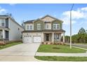 Charming two-story home with a two-car garage, covered porch, and well-maintained landscaping at 749 Aristocrat Ln, Knightdale, NC 27545