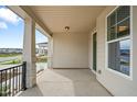 Welcoming covered porch with stone accents and black railing, offering a cozy outdoor space at 749 Aristocrat Ln, Knightdale, NC 27545