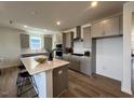 Beautiful eat-in kitchen with large island, modern appliances, light gray cabinets, and modern lighting at 813 Emmer St, Rolesville, NC 27571