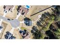 An aerial view of a home in a neighborhood featuring a pool, fire pit, and ample landscaping at 99 Bodacious Ln, Benson, NC 27504