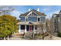 Beautiful two-story home with inviting front porch, eye-catching pink door, and mature trees at 101 S Bloodworth St, Raleigh, NC 27601