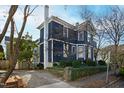 A lovely blue house is surrounded by greenery, offering a serene and private setting at 101 S Bloodworth St, Raleigh, NC 27601