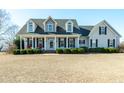 Charming two-story home with dormer windows and a spacious front yard at 105 Bagley Ln, Dunn, NC 28334