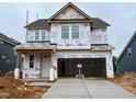 A home under construction, showing the garage and initial facade, including windows at 107 Willow Cameron Way, Angier, NC 27501