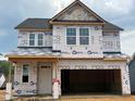 New construction home with wrap, showcasing the framing and window placement at 107 Willow Cameron Way, Angier, NC 27501